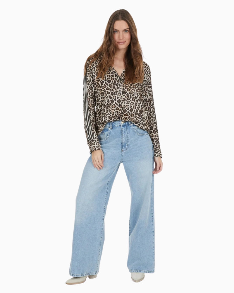 Styled blouse paired with tailored trousers for a dressy yet comfortable outfit
