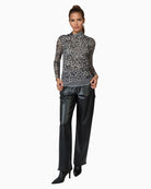 Styled outfit with mesh top paired with trousers for a modern layered look