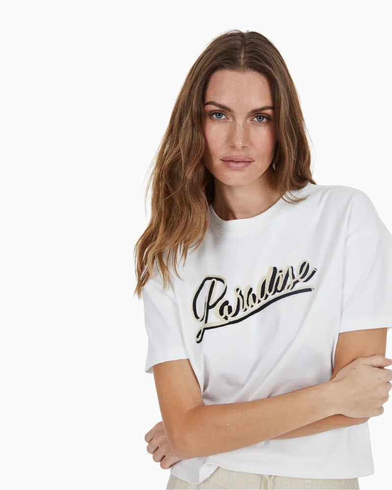Close-up of embroidered “Paradise” text on chest
