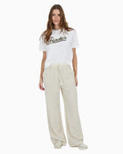 Styled outfit pairing the tee with high-waisted trousers