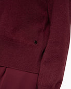 Detail of soft cashmere knit texture in rich maroon hue