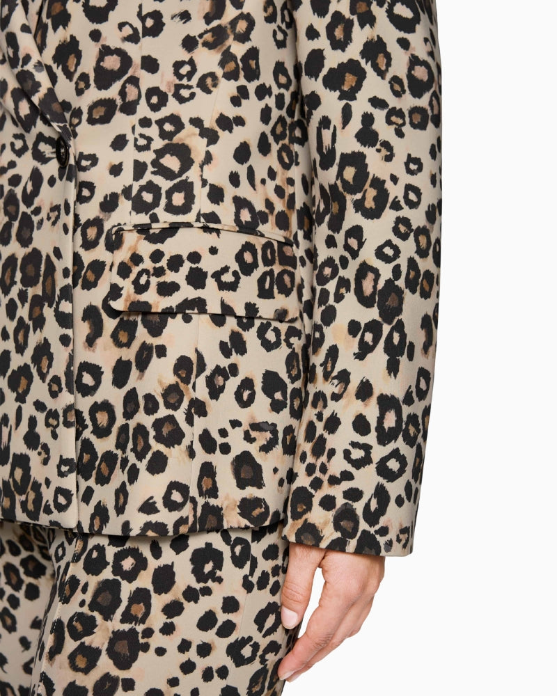 Close-up of leopard print fabric texture and button detail