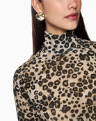 Detail of high turtleneck collar and velvety texture on Marc Cain leopard top