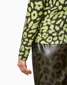 Close-up back view of lime animal print jersey fabric
