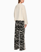 Marc Cain WELKOM wide-leg trousers with animal print black back view on woman wearing them – Áines Boutique