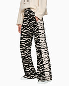 Marc Cain WELKOM wide-leg trousers with animal print black side view on woman wearing them – Áines Boutique