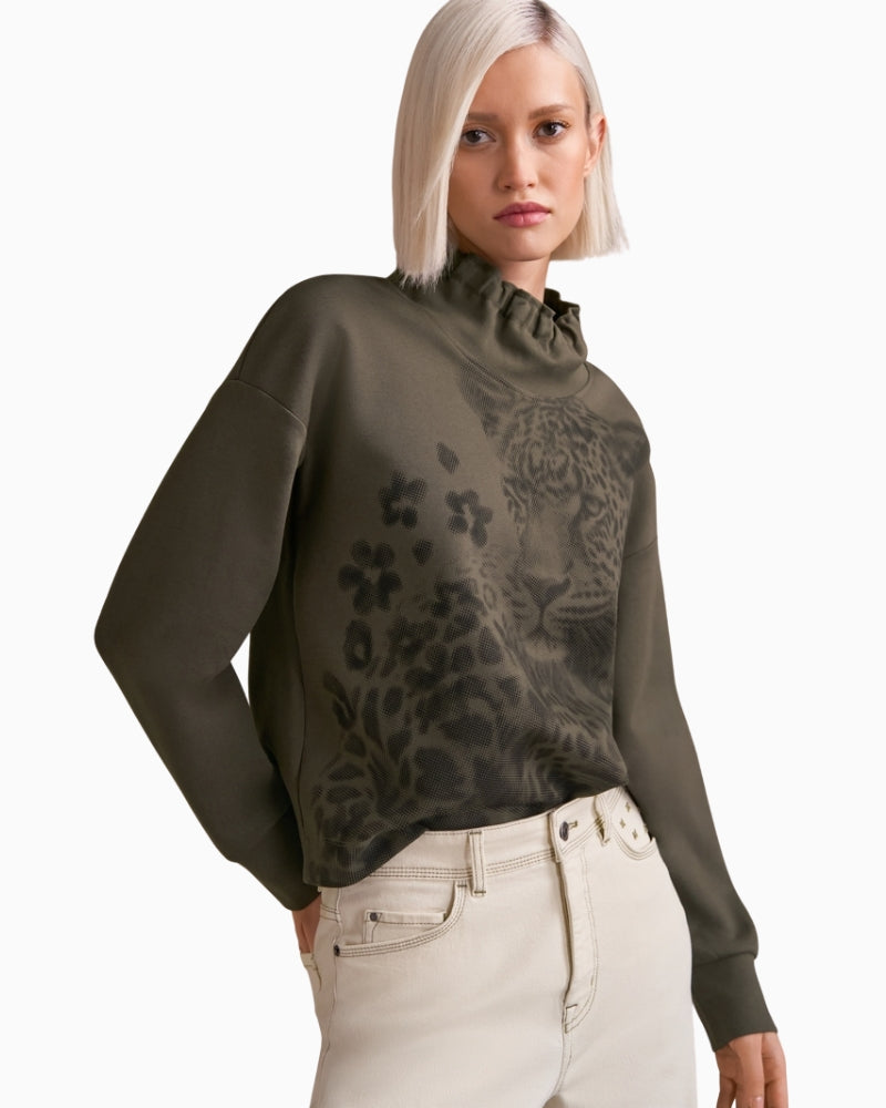 Model styled in WIGAN trousers with trainers and blouse