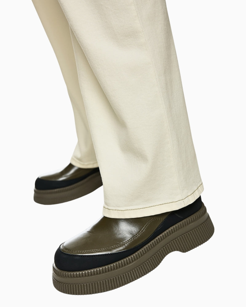 Side view of wide-leg puddle jeans covering the shoes