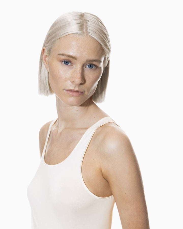 Close up of Champagne-coloured tank top by Mey with wide straps and seamless finish