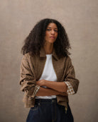 Model wearing cropped tartan shirt jacket with white background studio shot