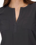 Close-up of round neck with rhinestones and front slit on Monari blouse