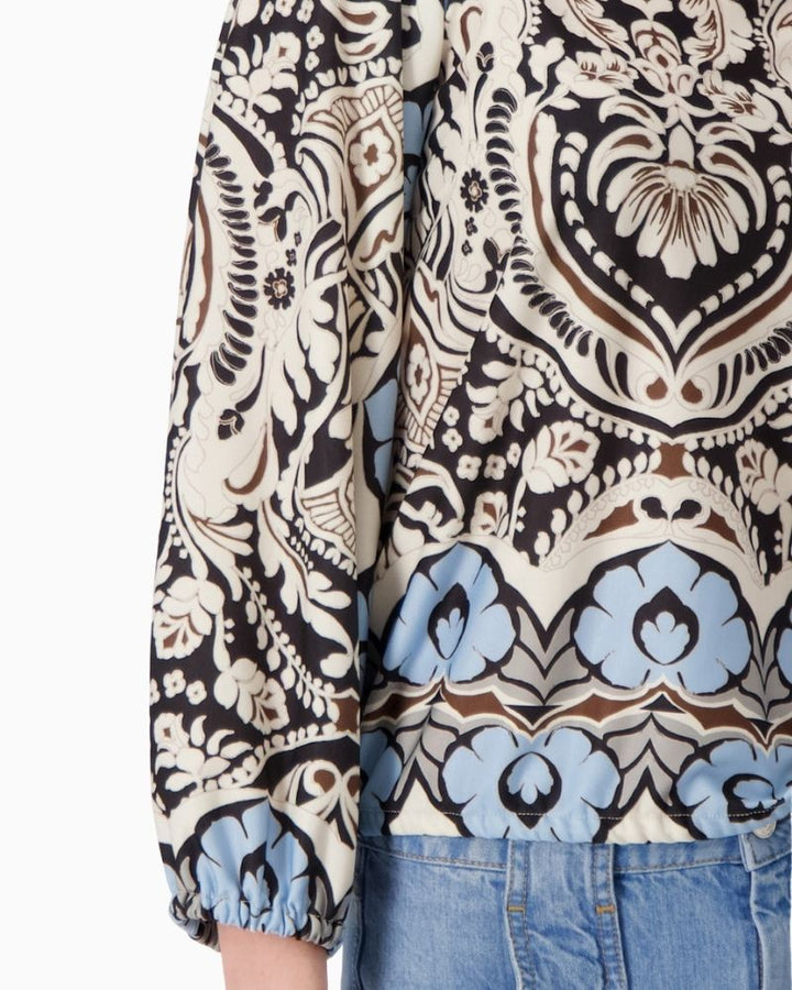 Close-up of Monari blouse fabric detail with all-over ornamental design