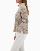 Side view of textured chenille jumper with stand-up collar