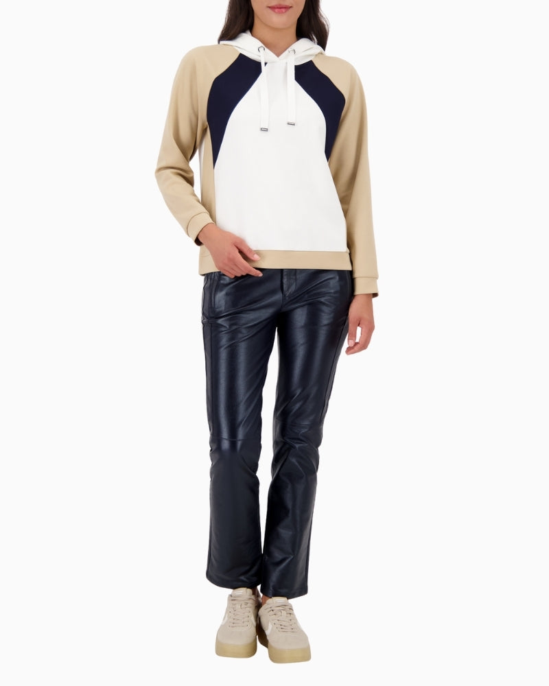 Model wearing Monari hooded jumper styled casually with trousers