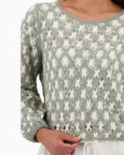 Close-up of sequin embellishment and cornely stitch pattern