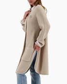 Side view of Monari knit coat showing longline cut and relaxed fit