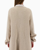 Back view of long beige cardigan with clean finish