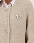 Close-up of brooch detail on soft wool knit fabric