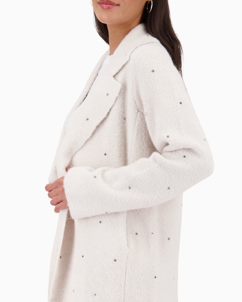 Side view of Monari coat showing relaxed fit and stud trim