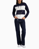 Woman wearing Monari knitted jumper with emblem navy styled casually – Áines Boutique