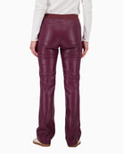 Back view of faux leather trousers with patch pockets