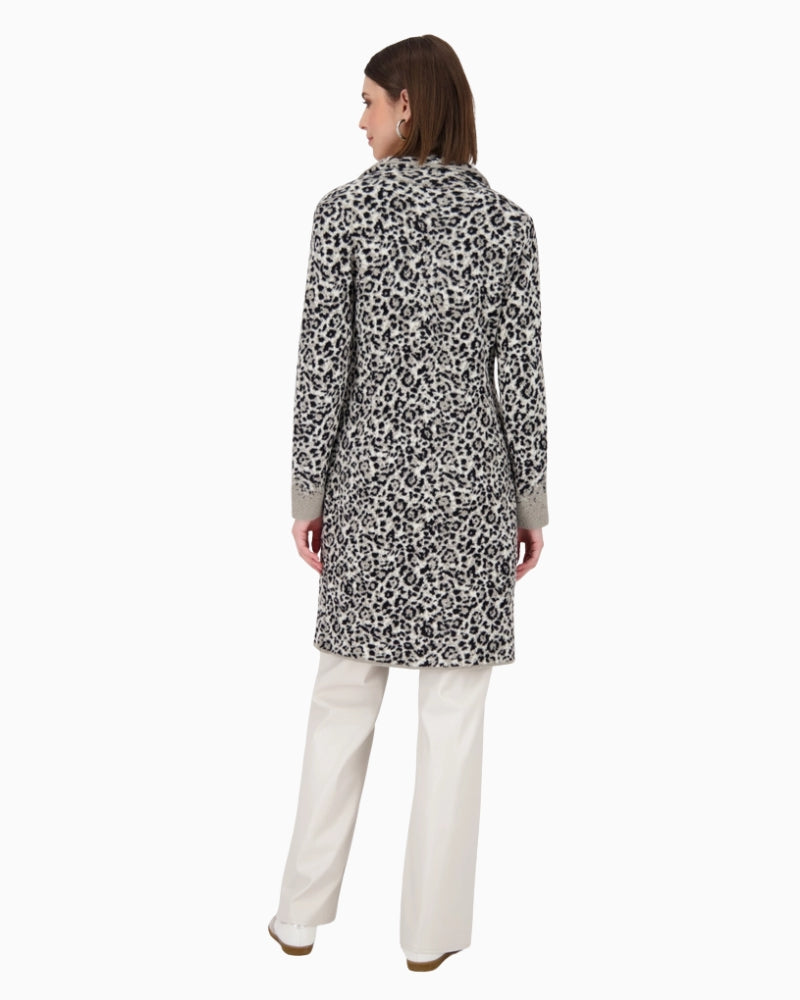 Back view of mid-length knitted coat showing dropped shoulders and relaxed fit