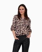 Front view of Monari leopard print blouse with round slit neckline