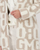 Close up of Monari letter print jacket with fluffy texture and lapel collar
