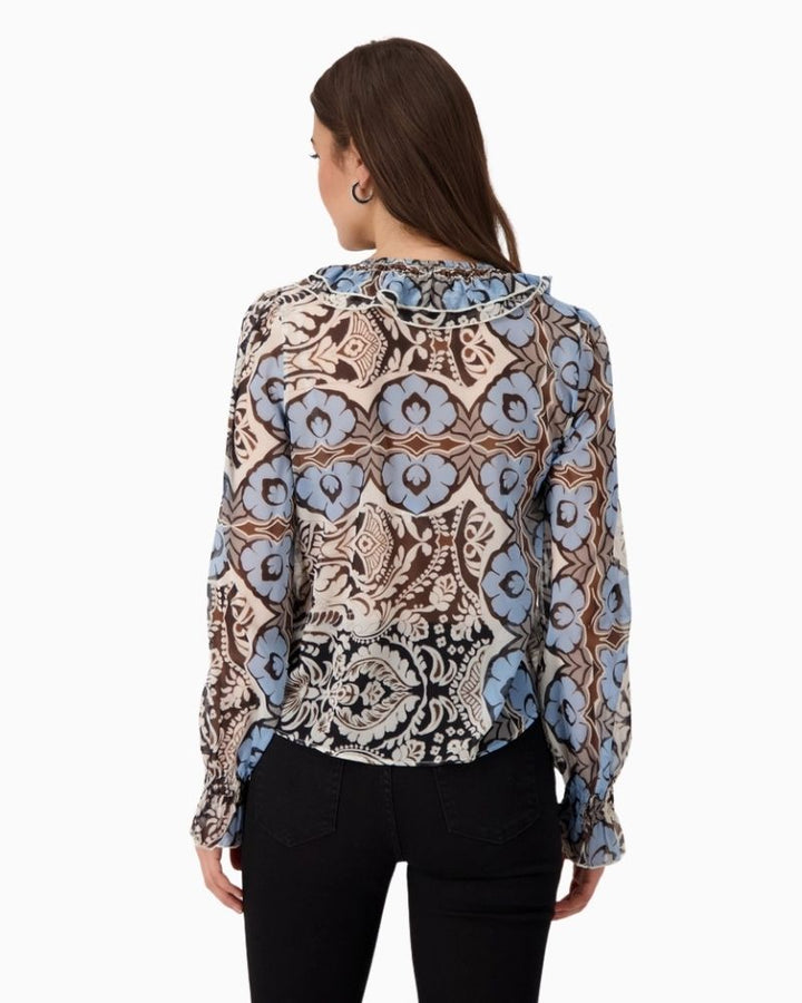 Back view of Monari blouse with rounded hem and side slits