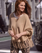 Front view of Monari oversized poncho with V-neck and fringe hem