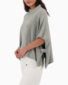 Side view of Monari sequin cape showing oversized shoulder design