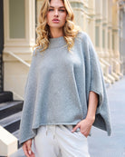 Front view of sparkly cape with stand-up collar and ¾ sleeves