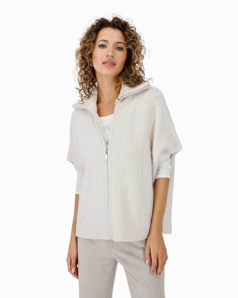 Monari beige cable knit cape draped over shoulders