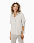 Monari beige cable knit cape draped over shoulders