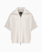 Front view of open-front knitted cape in soft beige