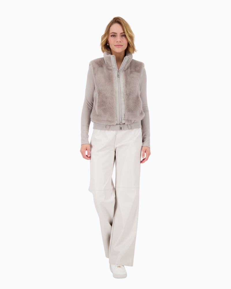 Model wearing grey Monari gilet layered over a jumper and jeans