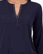 Close-up of rhinestone neckline detail on Monari navy blouse