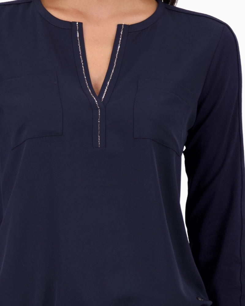 Close-up of rhinestone neckline detail on Monari navy blouse