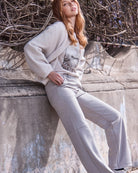 Model wearing shirt and cardigan paired with Monari Trousers