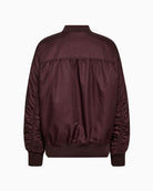 Back view of Ruby bomber showing pleat detail and elasticated hem