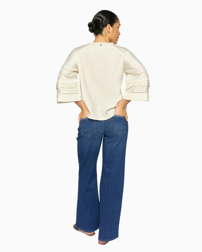 Woman wearing Mos Mosh flared stretch denim jeans, back view – Áines Boutique