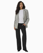 Model wearing Disa blazer with jeans for a relaxed smart-casual look