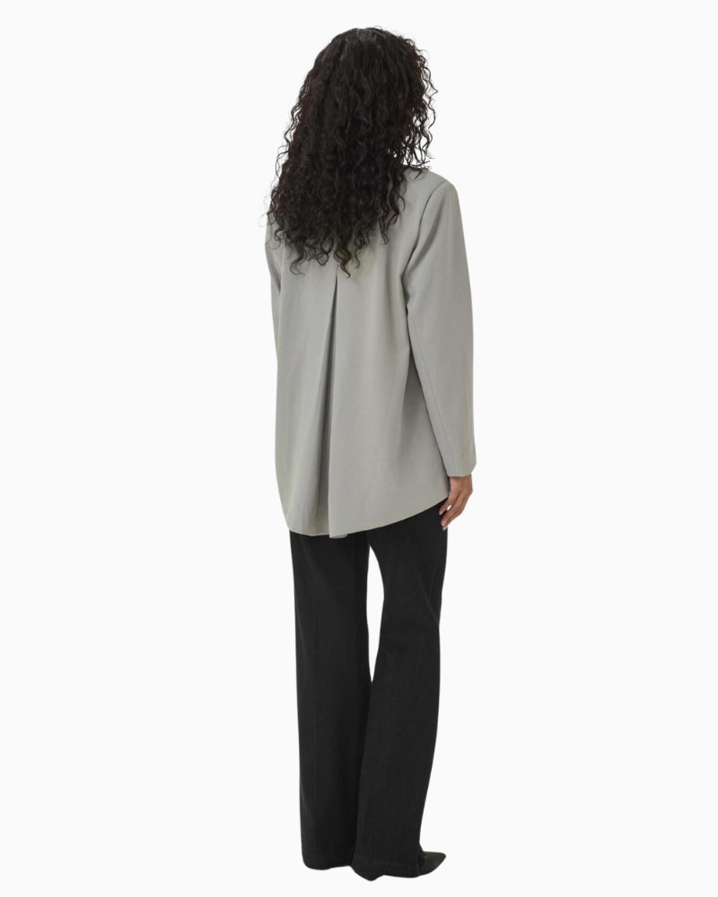 Back view of tailored blazer showing soft seam shaping