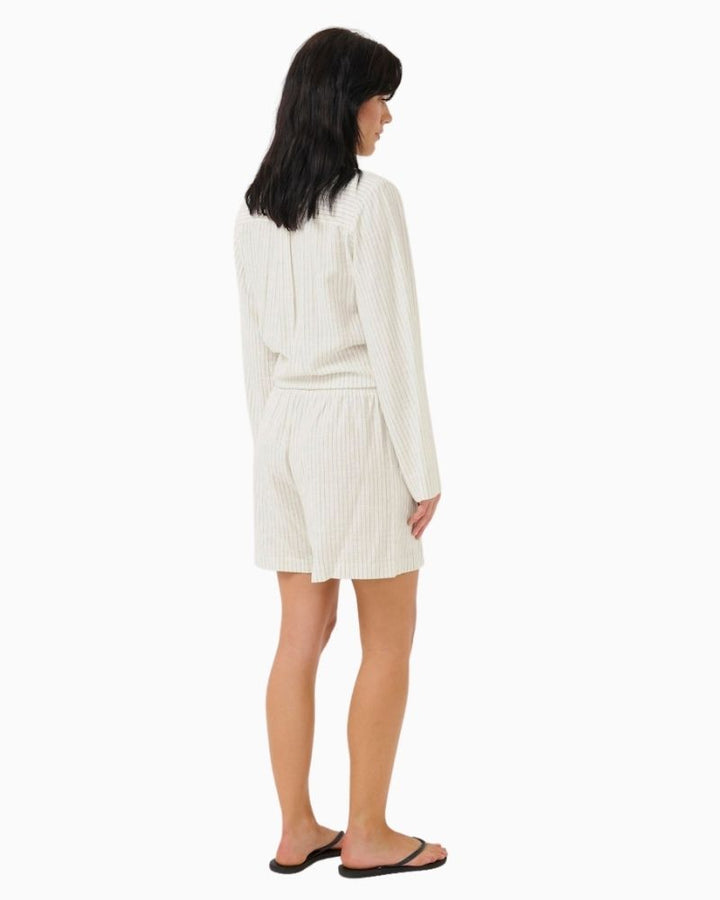 Back of Casual fit summer shorts in neutral fabric styled with simple top and sandals