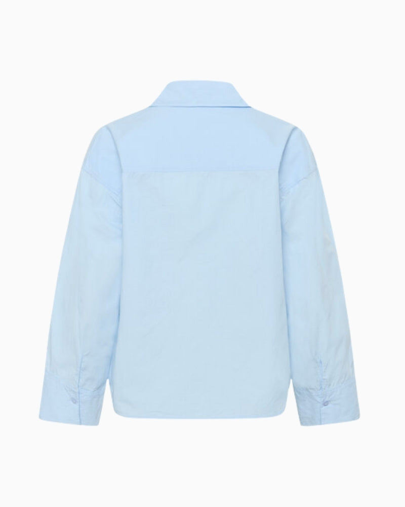 My Essential Wardrobe blue shirt flat back view boxy fit