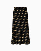 Never Fully Dressed Dorris Skirt in Black front view showing metallic gold polka dots and flowing maxi silhouette