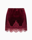 Never Fully Dressed Velvet Mini Maeva Skirt in Burgundy back view with scalloped lace trim