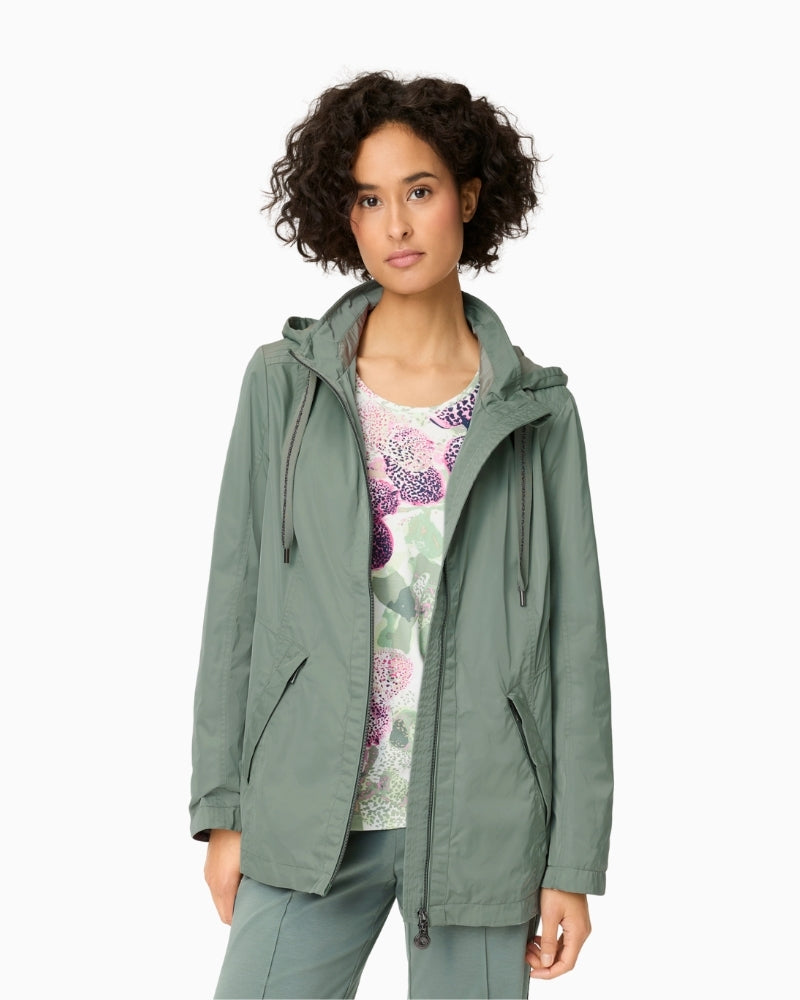 Woman wearing Olsen sage green hooded jacket styled casually – Áines Boutique