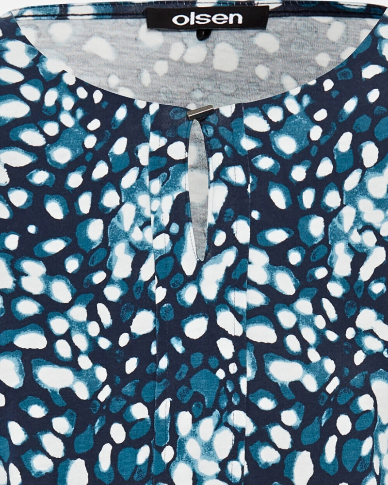 Close-up of button detail on split round neckline