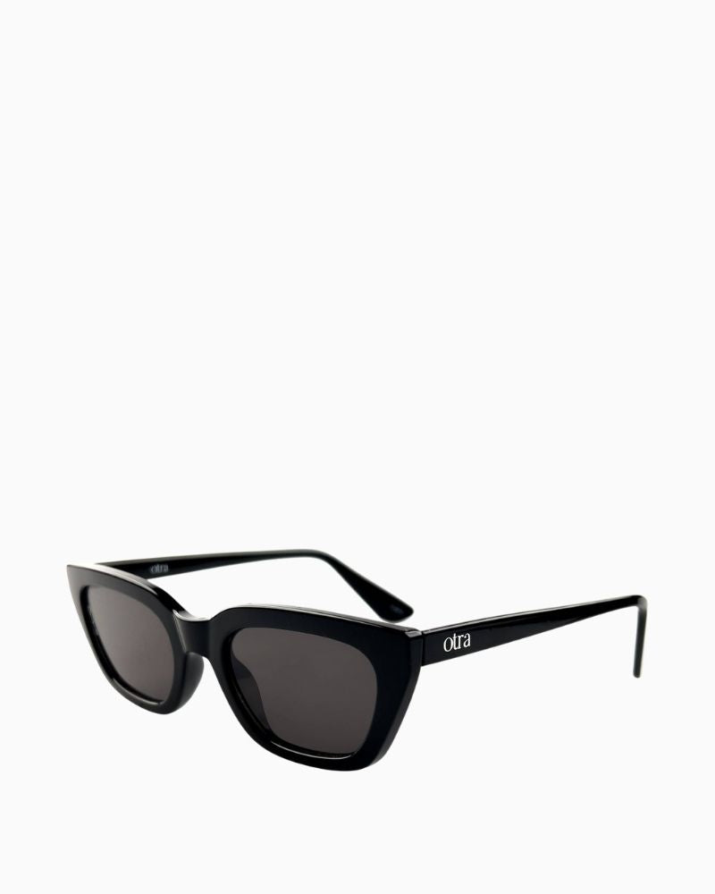 Side view of Otra Nove sunglasses showing sleek black finish and vegan pouch